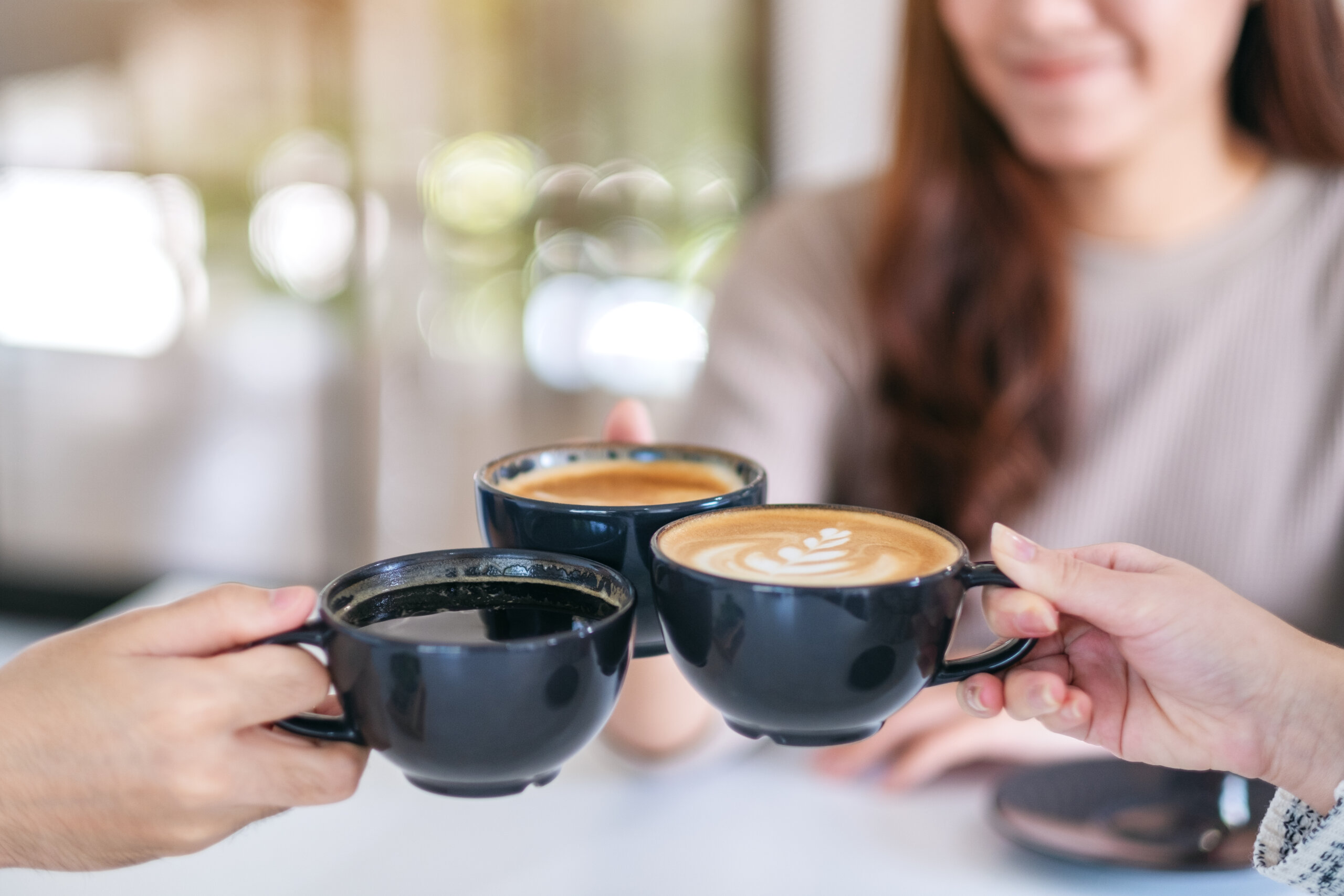 Closeup image of people enjoyed drinking and clinking coffee cup